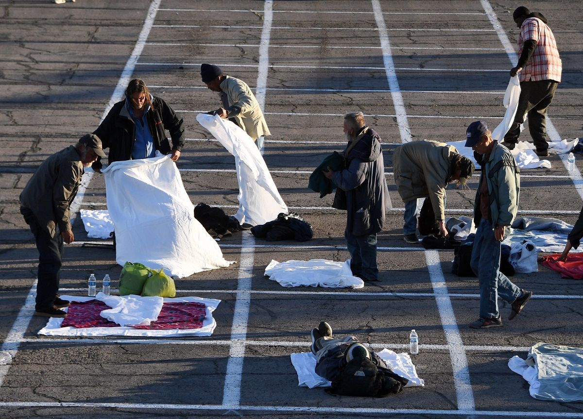 LAS VEGAS, NEVADA - MARCH 30:  People arrive at a temporary homeless shelter with painted social-distancing boxes in a parking lot at Cashman Center on March 30, 2020 in Las Vegas, Nevada. Catholic Charities of Southern Nevada was closed last week after a homeless man who used their services tested positive for the coronavirus, leaving about 500 people with no overnight shelter. The city of Las Vegas, Clark County and local homeless providers plan to operate the shelter through April 3rd when it is anticipated that the Catholic Charities facility will be back open. The city is also reserving the building spaces at Cashman Center in case of an overflow of hospital patients. The World Health Organization declared the coronavirus (COVID-19) a global pandemic on March 11th.  (Photo by Ethan Miller/Getty Images) (Ethan Miller / Getty Images))