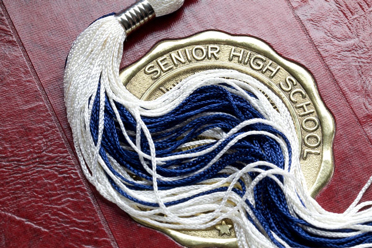 Mortar board tassel on high school year book. (Getty Images/Stock photo)