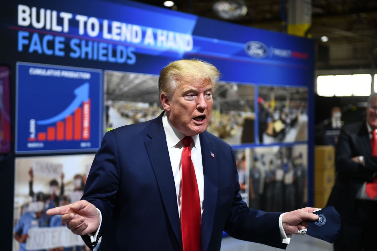US President Donald Trump  holds a mask as he speaks during a tour of the Ford Rawsonville Plant in Ypsilanti, Michigan on May 21, 2020. (Photo by Brendan Smialowski / AFP) (Photo by BRENDAN SMIALOWSKI/AFP via Getty Images) ( BRENDAN SMIALOWSKI/AFP via Getty Images)