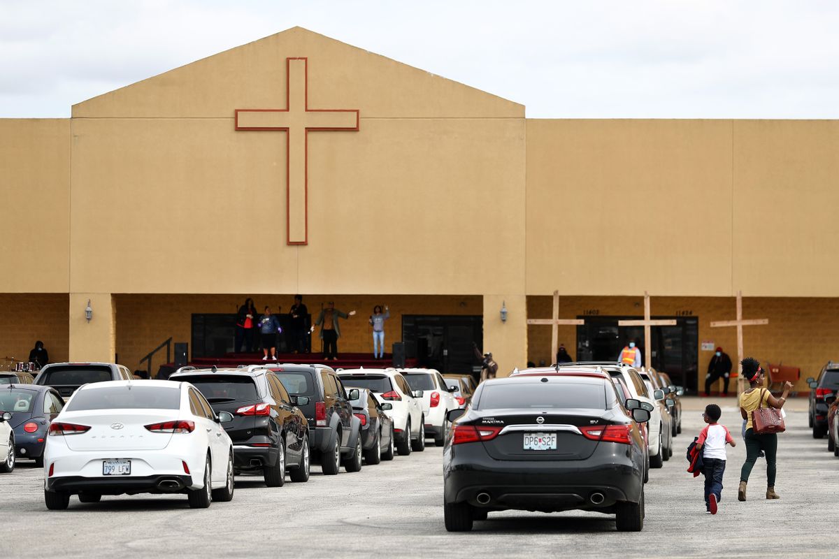 KANSAS CITY, MO - APRIL 12:   Worshipers inside cars line up in the parking lot for Easter Sunday morning service at the Memorial Missionary Baptist Church on April 12, 2020 in Kansas City, Missouri. Many states are restricting Easter church gatherings during the coronavirus (COVID-19) pandemic, while some religious leaders are challenging the social distancing measures.  (Photo by Jamie Squire/Getty Images) (Jamie Squire/Getty Images)