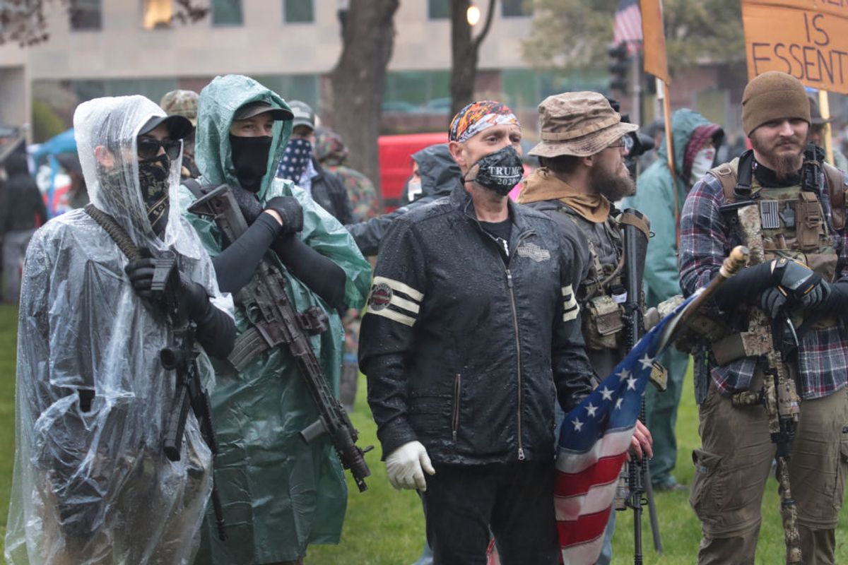 LANSING, MICHIGAN - MAY 14: Demonstrators carrying guns hold a rally in front of the Michigan state capital building to protest the governor's stay-at-home order on May 14, 2020 in Lansing, Michigan. Governor Gretchen Whitmer imposed the order to curtail the spread of the coronavirus COVID-19.  (Photo by Scott Olson/Getty Images) (Scott Olson/Getty Images)