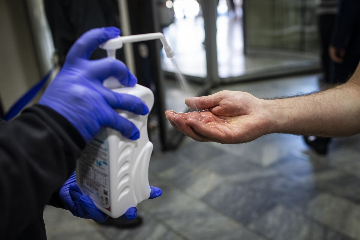 ANKARA, TURKEY - MAY 14: Private security guard offers hand sanitizer to a visitor within the coronavirus (Covid-19) pandemic precautions in Gazi Hospital in Ankara, Turkey on May 14, 2020. Security guards check the temperature of the visitors of the hospital and make sure they wear masks before entering the hospital. (Photo by Ozge Elif Kizil/Anadolu Agency via Getty Images) (Getty Images)