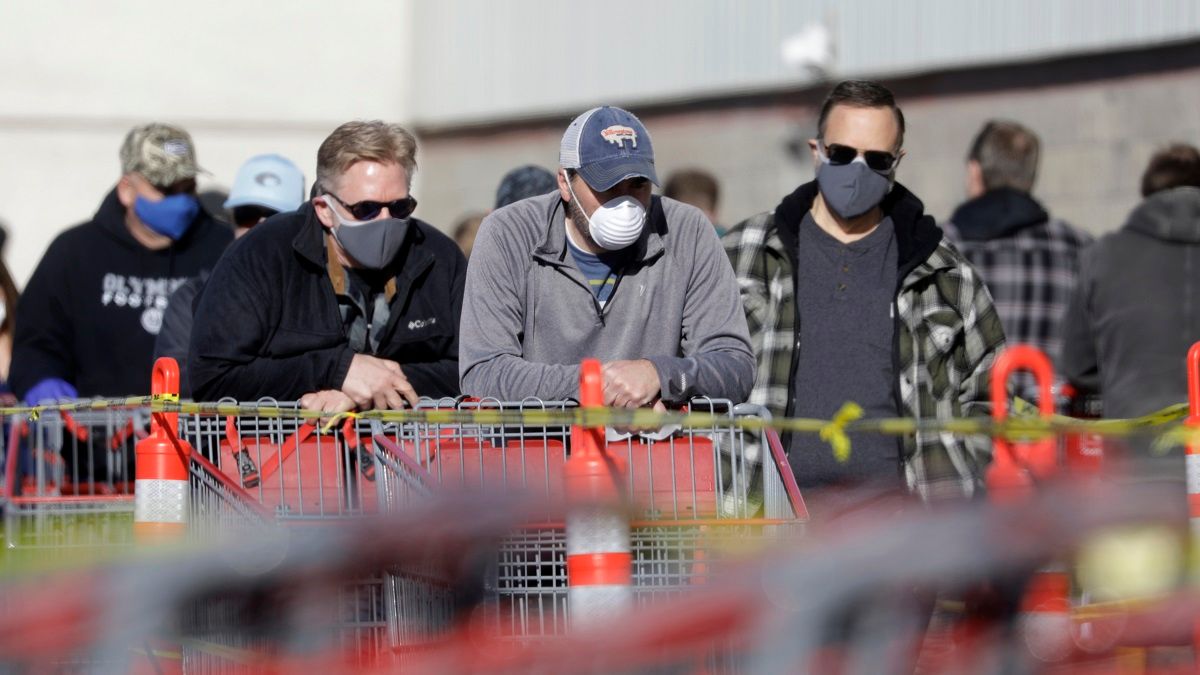 People wear masks as they wait in line at Costco Saturday, April 4, 2020, in Salt Lake City. The Centers for Disease Control and Prevention is now advising Americans to voluntarily wear a basic cloth or fabric face mask to help curb the spread of the new coronavirus. (AP Photo/Rick Bowmer) (Associated Press / Rick Bowmer)