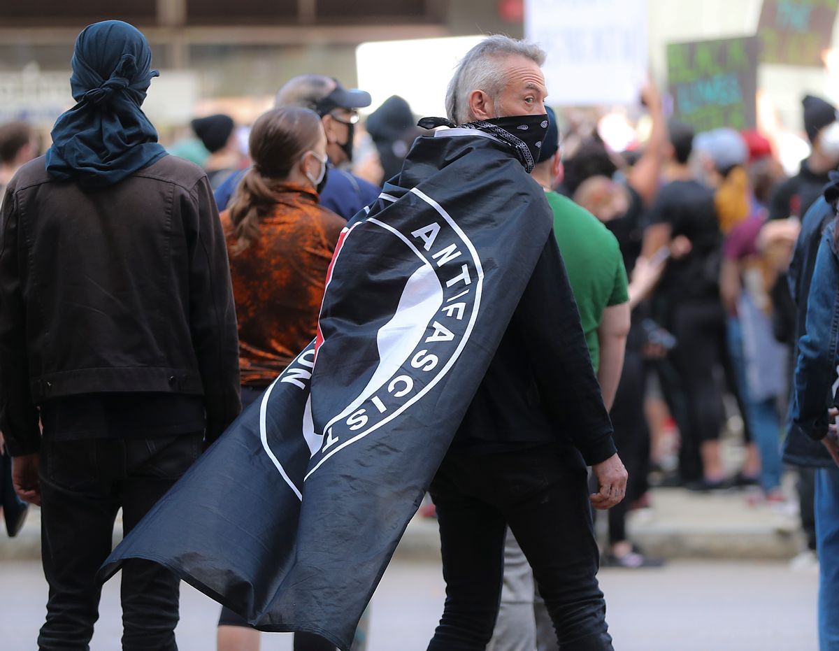 BOSTON, MA - JUNE 1: Hundreds of protesters gather at Government Center including a protester with an ANTIFA flag draped over his shoulders during a rally sponsored by the Youth of Greater Boston to demand justice for George and support of the Black Lives Matter movement in Boston on May 31, 2020, (Photo by Matthew J. Lee/The Boston Globe via Getty Images) (Matthew J. Lee/The Boston Globe via Getty Images)