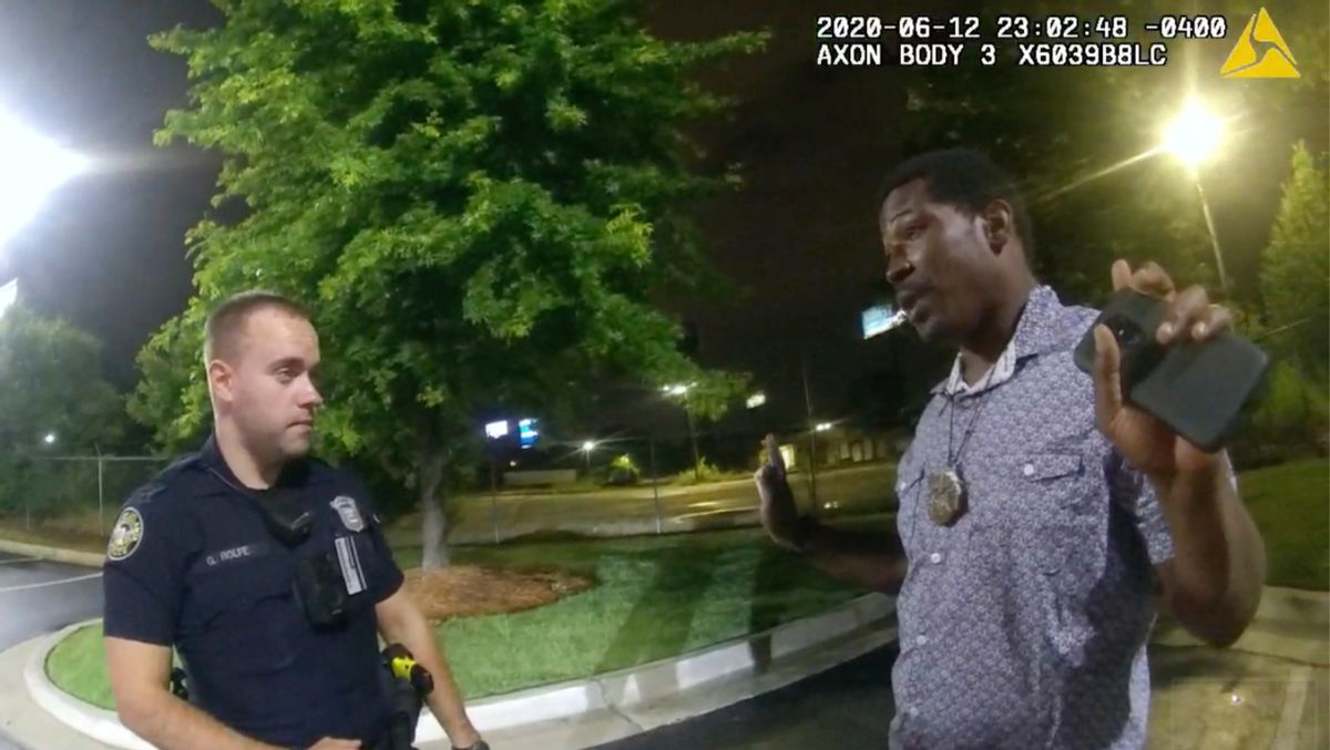 This screen grab taken from body camera video provided by the Atlanta Police Department shows Rayshard Brooks speaking with Officer Garrett Rolfe in the parking lot of a Wendy's restaurant, late Friday, June 12, 2020, in Atlanta. Rolfe has been fired following the fatal shooting of Brooks and a second officer has been placed on administrative duty. (Atlanta Police Department via AP) (Atlanta Police Department via AP)