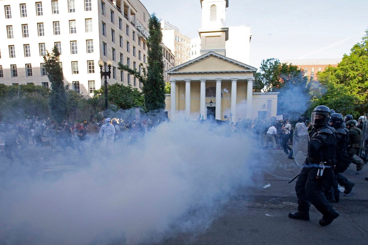 TOPSHOT - Police officers wearing riot gear push back demonstrators shooting tear gas next to St. John's Episcopal Church  outside of the White House, June 1, 2020 in Washington D.C., during a protest over the death of George Floyd. - President Trump visited the church while demonstrators where protesting. With the Trump administration branding instigators of six nights of rioting as domestic terrorists, there were more confrontations between protestors and police and fresh outbreaks of looting. Local US leaders appealed to citizens to give constructive outlet to their rage over the death of an unarmed black man in Minneapolis, while night-time curfews were imposed in cities including Washington, Los Angeles and Houston. (Photo by Jose Luis Magana / AFP) (Photo by JOSE LUIS MAGANA/AFP via Getty Images) (JOSE LUIS MAGANA / AFP via Getty Images)