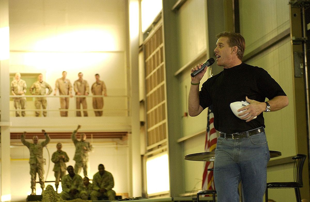 041213-F-2270A-424.Hall of Fame Quarterback John Elway talks to the troops as he gets ready to fire a few footballs to the crowd at Ali al Salem Air Base, Kuwait, during a United Services Organization tour on Dec. 13, 2004.  Elway joined Chairman of the Joint Chiefs of Staff Gen. Richard B. Myers, U.S. Air Force, and Blake Clarke, Leann Tweedon and Robin Williams on the USO tour to meet, entertain and thank the deployed troops.  DoD photo by Tech. Sgt. Scott M. Ash, U.S. Air Force.  (Released) (Wikipedia)