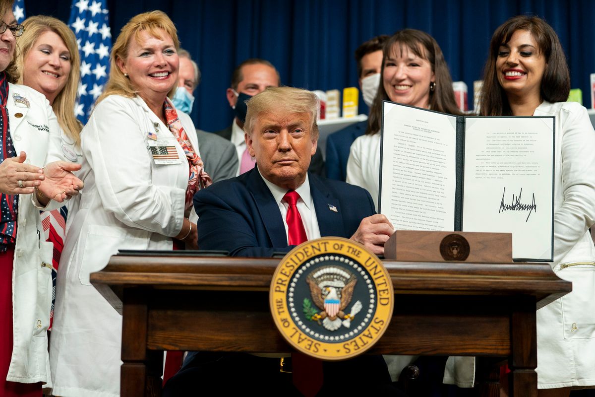 U.S. President Donald Trump displays his signature after signing executive orders on lowering drug prices on July 24, 2020. Photo by Shealah Craighead and available via Flickr. (The White House)