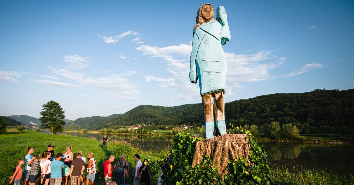 TOPSHOT - People gather around what conceptual artist Ales 'Maxi' Zupevc claims is the first ever monument of Melania Trump, set in the fields near the town of Sevnica, US First Ladys hometown, during a small inauguration celebration on July 5, 2019. - After Melania cake, Melania honey, and even Melania slippers, the Slovenian hometown of the US's first lady will now boast a statue of its most famous daughter -- albeit one which has faced decidedly mixed reviews. The life-size statue on the outskirts of Sevnica was inaugurated on July 5, 2019. (Photo by Jure Makovec / AFP) / RESTRICTED TO EDITORIAL USE - MANDATORY MENTION OF THE ARTIST UPON PUBLICATION - TO ILLUSTRATE THE EVENT AS SPECIFIED IN THE CAPTION        (Photo credit should read JURE MAKOVEC/AFP via Getty Images) (JURE MAKOVEC/AFP via Getty Images)