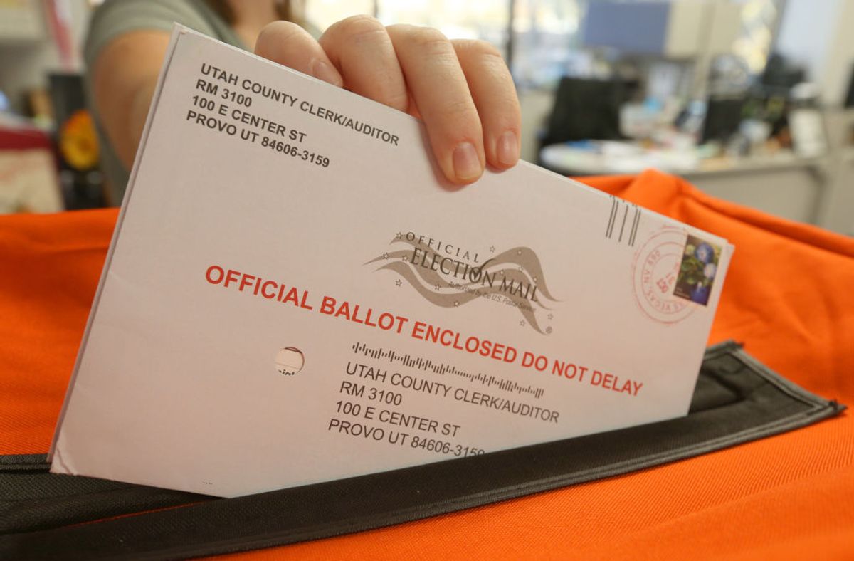 PROVO, UT - November 6: A employee at the Utah County Election office puts mail in ballots into a container to register the vote in the midterm elections on November 6, 2018 in Provo, Utah. Utah early voting has been the highest ever in Utah's midterm elections. One of the main proportions on the ballot in Utah is whether Utah will legalize medical marijuana.  (Photo by George Frey/Getty Images) (George Frey/Getty Images)