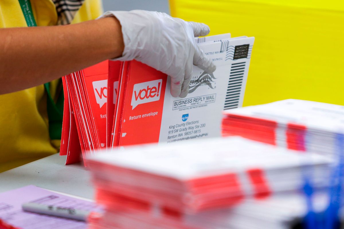 An election worker opens envelopes containing vote-by-mail ballots for the August 4 Washington state primary at King County Elections in Renton, Washington on August 3, 2020. (Photo by Jason Redmond / AFP) (Photo by JASON REDMOND/AFP via Getty Images) (JASON REDMOND/AFP via Getty Images)