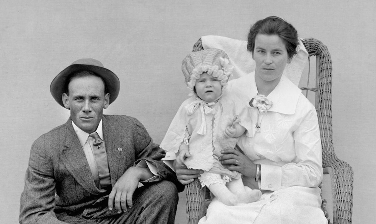 Mother and father pose with their baby early in the 20th century. (Photo by Kirn Vintage Stock/Corbis via Getty Images) (Getty Images)