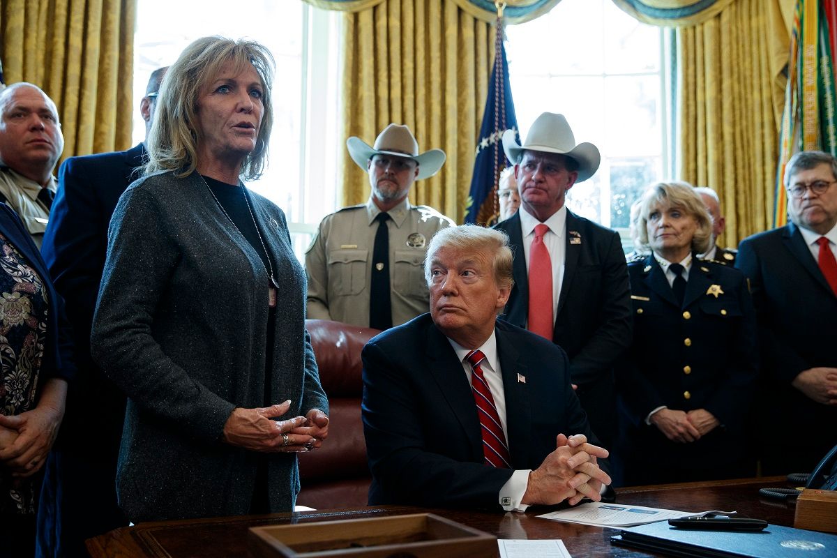 President Donald Trump listens as Mary Ann Mendoza, an "Angel Mom" who lost her son Brandon when he was killed by a drunk driver that was an undocumented immigrant, speaks before he signs the first veto of his presidency in the Oval Office of the White House, Friday, March 15, 2019, in Washington. Trump issued the first veto, overruling Congress to protect his emergency declaration for border wall funding. (AP Photo/Evan Vucci) (AP Photo / Evan Vucci)