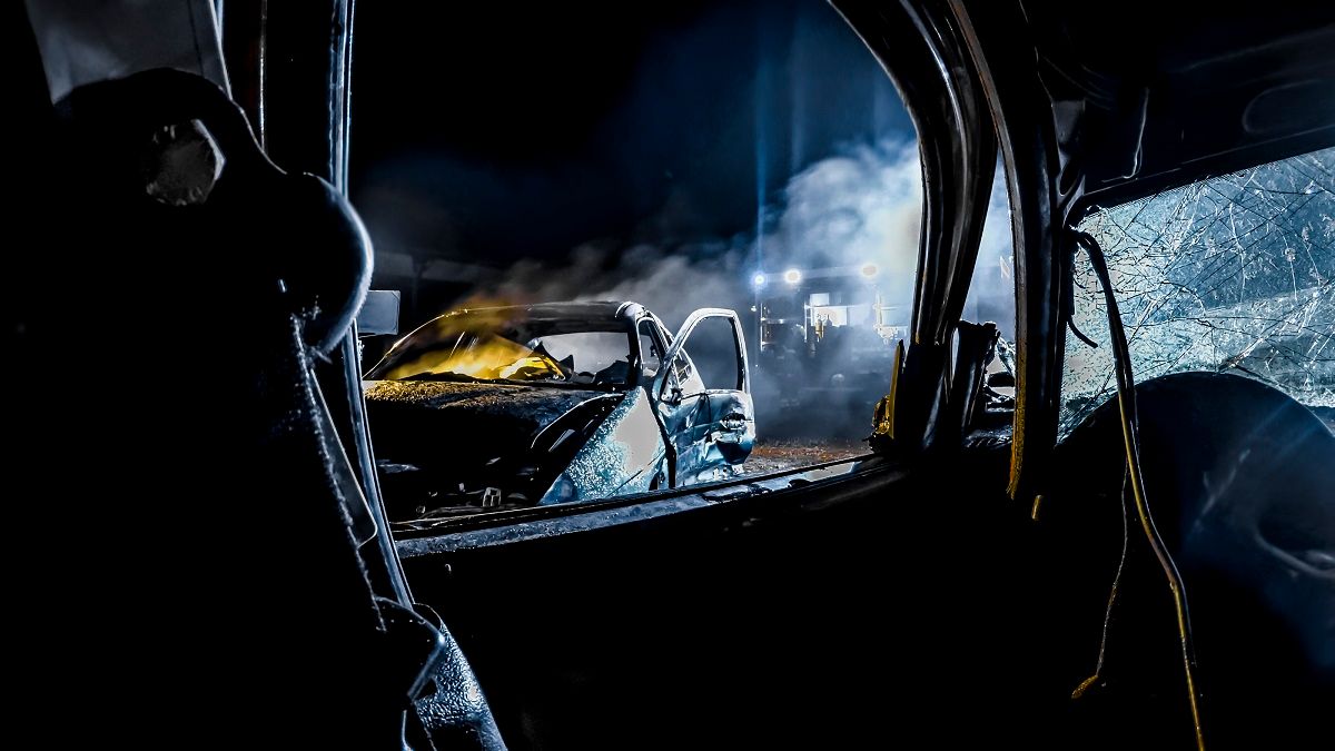 Crashed car burning at night. (Getty Images /  simonkr)