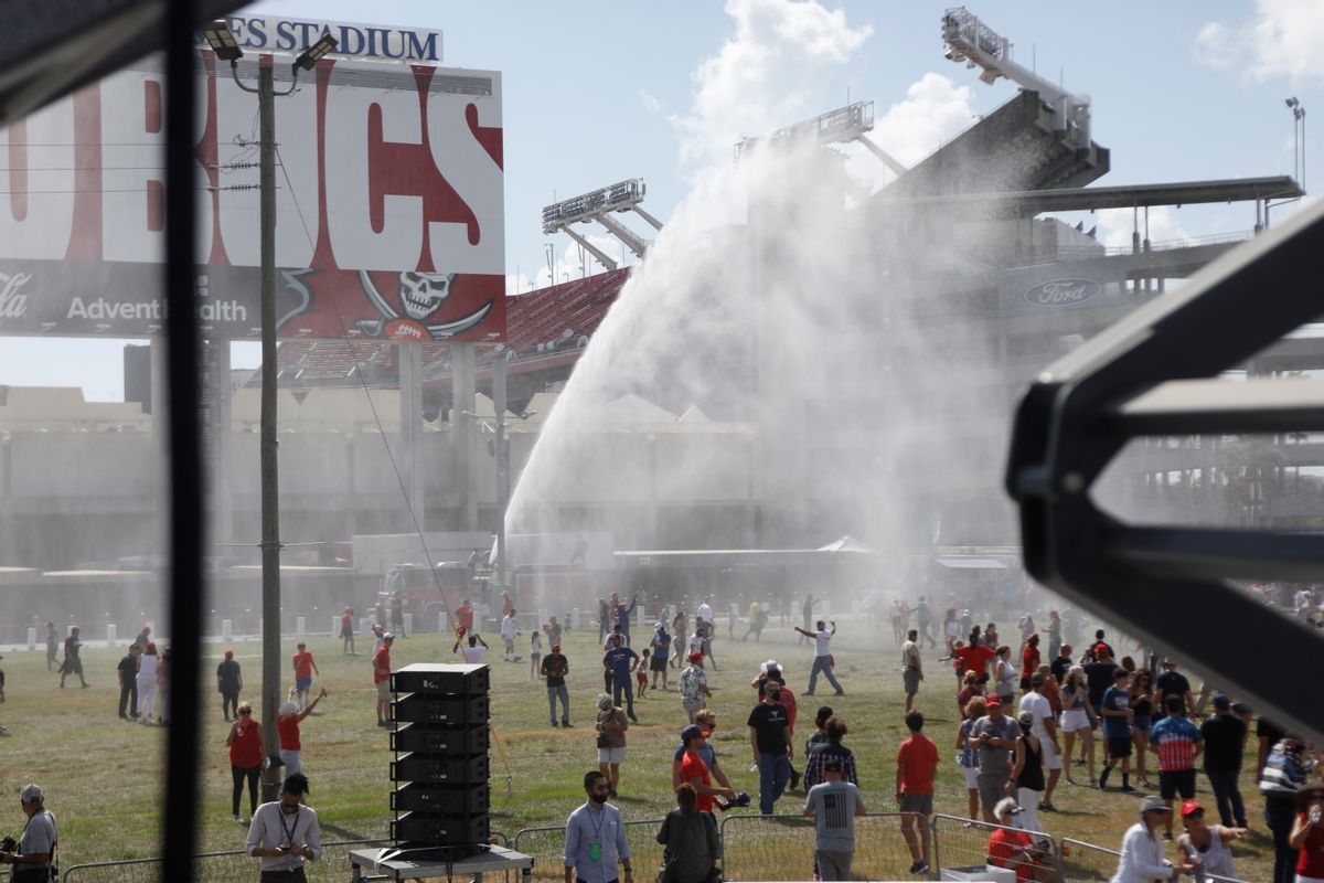 TAMPA, FL - OCTOBER 29: Tampa Fire Rescue sprays water to cool off supporters of President Donald Trump during his campaign speech just four days before Election Day outside of Raymond James Stadium on October 29, 2020 in Tampa, Florida. With less than a week until Election Day, Trump and his opponent, Democratic presidential nominee Joe Biden, are campaigning across the country. (Photo by Octavio Jones/Getty Images) (Octavio Jones/Getty Images)