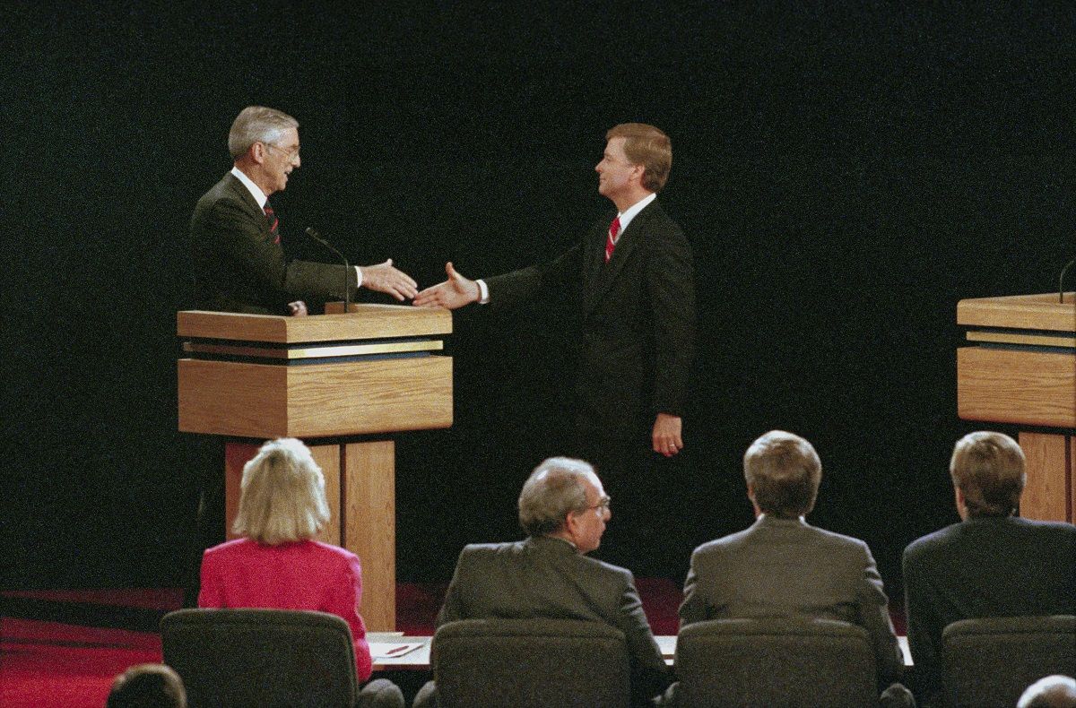 (Original Caption) Omaha, Nebraska: Following their vice presidential debate, Senators Lloyd Bentsen (L) of Texas and Dan Quayle (R) of Indiana reach out to shake hands, October 5th. (Bettmann via Getty)
