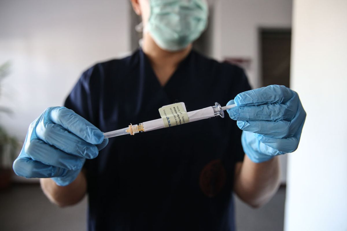 ANKARA, TURKEY - OCTOBER 27: A health care worker holds an injection syringe of the phase 3 vaccine trial, developed against the novel coronavirus (COVID-19) pandemic by the U.S. Pfizer and German BioNTech company, at the Ankara University Ibni Sina Hospital in Ankara, Turkey on October 27, 2020. This vaccine candidate, within the scope of phase 3 studies, was injected to volunteers in Ankara University Ibni Sina Hospital. (Photo by Dogukan Keskinkilic/Anadolu Agency via Getty Images) (Anadolu Agency / Contributor)