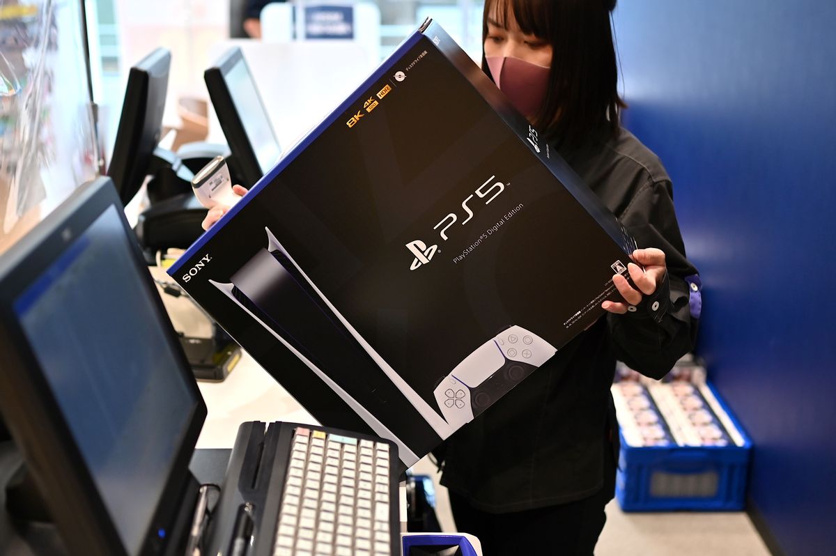 An employee prepares the new Sony PlayStation 5 gaming console for a customer on the first day of its launch, at an electronics shop in Kawasaki, Kanagawa prefecture on November 12, 2020. (Photo by CHARLY TRIBALLEAU / AFP) (Photo by CHARLY TRIBALLEAU/AFP via Getty Images) (CHARLY TRIBALLEAU/AFP via Getty Images)