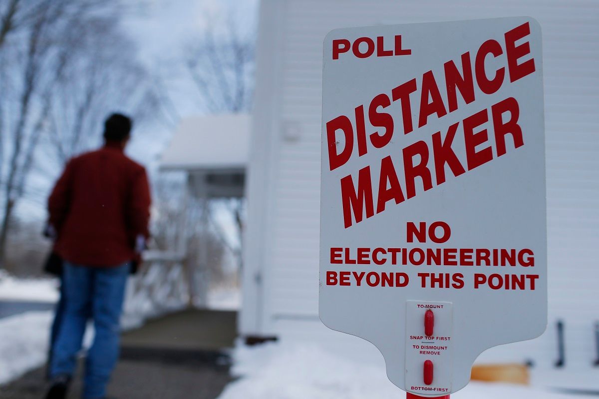 CHICHESTER, NH - FEBRUARY 9: A voters walks into a polling station past the poll distance marker to vote in the New Hampshire presidential primary election at the Town Hall in Chichester, N.H., Feb. 9, 2016. No electioneering is allowed beyond the point of the marker. (Photo by Jessica Rinaldi/The Boston Globe via Getty Images) (Jessica Rinaldi/The Boston Globe via Getty)