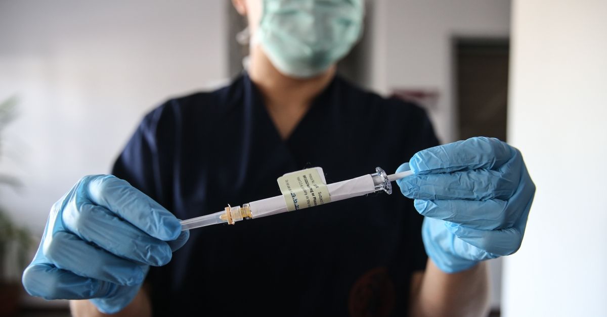 ANKARA, TURKEY - OCTOBER 27: A health care worker holds an injection syringe of the phase 3 vaccine trial, developed against the novel coronavirus (COVID-19) pandemic by the U.S. Pfizer and German BioNTech company, at the Ankara University Ibni Sina Hospital in Ankara, Turkey on October 27, 2020. This vaccine candidate, within the scope of phase 3 studies, was injected to volunteers in Ankara University Ibni Sina Hospital. (Photo by Dogukan Keskinkilic/Anadolu Agency via Getty Images) (Dogukan Keskinkilic/Anadolu Agency via Getty Images)