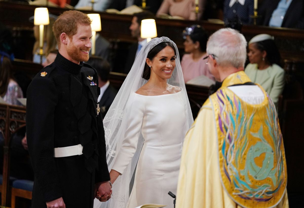 TOPSHOT - Britain's Prince Harry, Duke of Sussex (L) and US fiancee of Britain's Prince Harry Meghan Markle stand together hand in hand at the High Altar during their wedding ceremony in St George's Chapel, Windsor Castle, in Windsor, on May 19, 2018. (Photo by Dominic Lipinski / POOL / AFP)        (Photo credit should read DOMINIC LIPINSKI/AFP via Getty Images) (DOMINIC LIPINSKI/AFP via Getty Images)