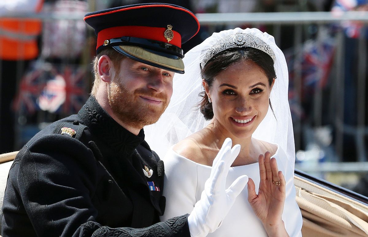 TOPSHOT - Britain's Prince Harry, Duke of Sussex and his wife Meghan, Duchess of Sussex wave from the Ascot Landau Carriage during their carriage procession on the Long Walk as they head back towards Windsor Castle in Windsor, on May 19, 2018 after their wedding ceremony. (Photo by Aaron Chown / POOL / AFP)        (Photo credit should read AARON CHOWN/AFP via Getty Images) (Aaron Chown/AFP via Getty Images)