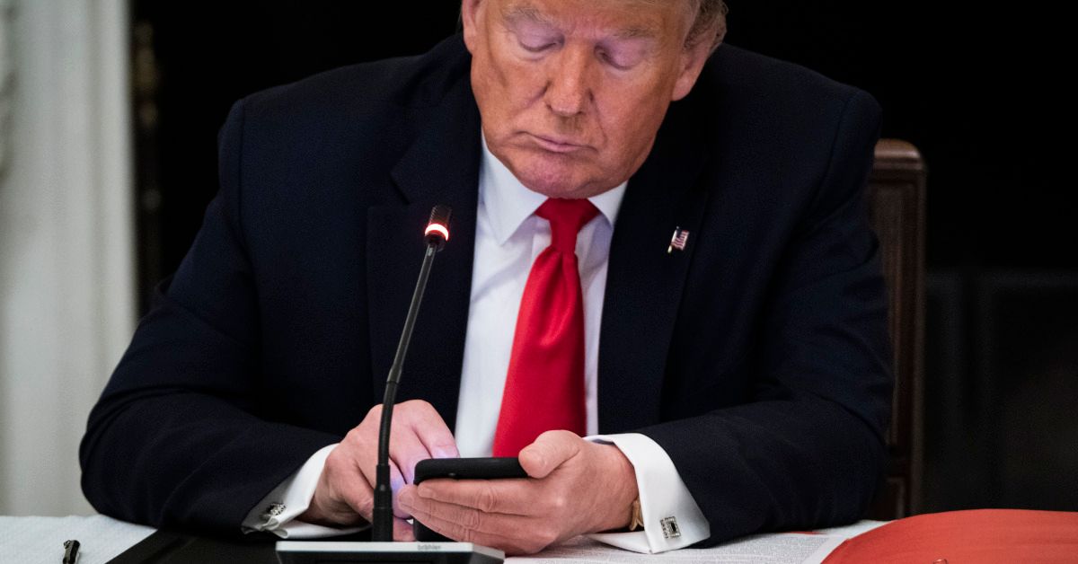 WASHINGTON, DC - JUNE 18: President Donald J. Trump uses his cellphone as he participates in a roundtable discussion with Governors and small business owners on the reopening of Americas small businesses in the State Dinning Room at the White House on Thursday, June 18, 2020 in Washington, DC. (Photo by Jabin Botsford/The Washington Post via Getty Images) (Jabin Botsford/The Washington Post via Getty Images)