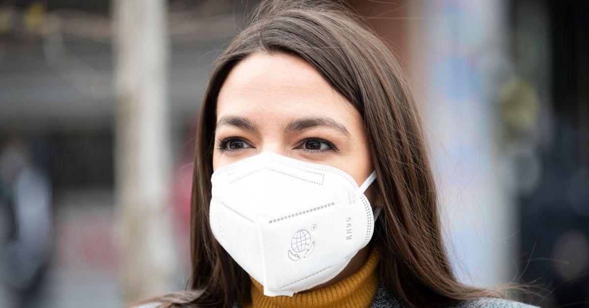 Democratic Congresswoman from New York Alexandria Ocasio-Cortez wears a face mask to protect herself from the coronavirus, during a press conference  in the Corona neighbourhood of Queens on April 14, 2020 in New York City. - Senate Minority Leader Chuck Schumer and Democratic Rep. Alexandria Ocasio-Cortez hold a press conference amid the coronavirus pandemic to call on the Federal Emergency Management Administration (FEMA) to begin approving disaster funds to help families in lower-income communities and communities of color pay for funeral costs. (Photo by Johannes EISELE / AFP) (Photo by JOHANNES EISELE/AFP via Getty Images) (JOHANNES EISELE/AFP via Getty Images)