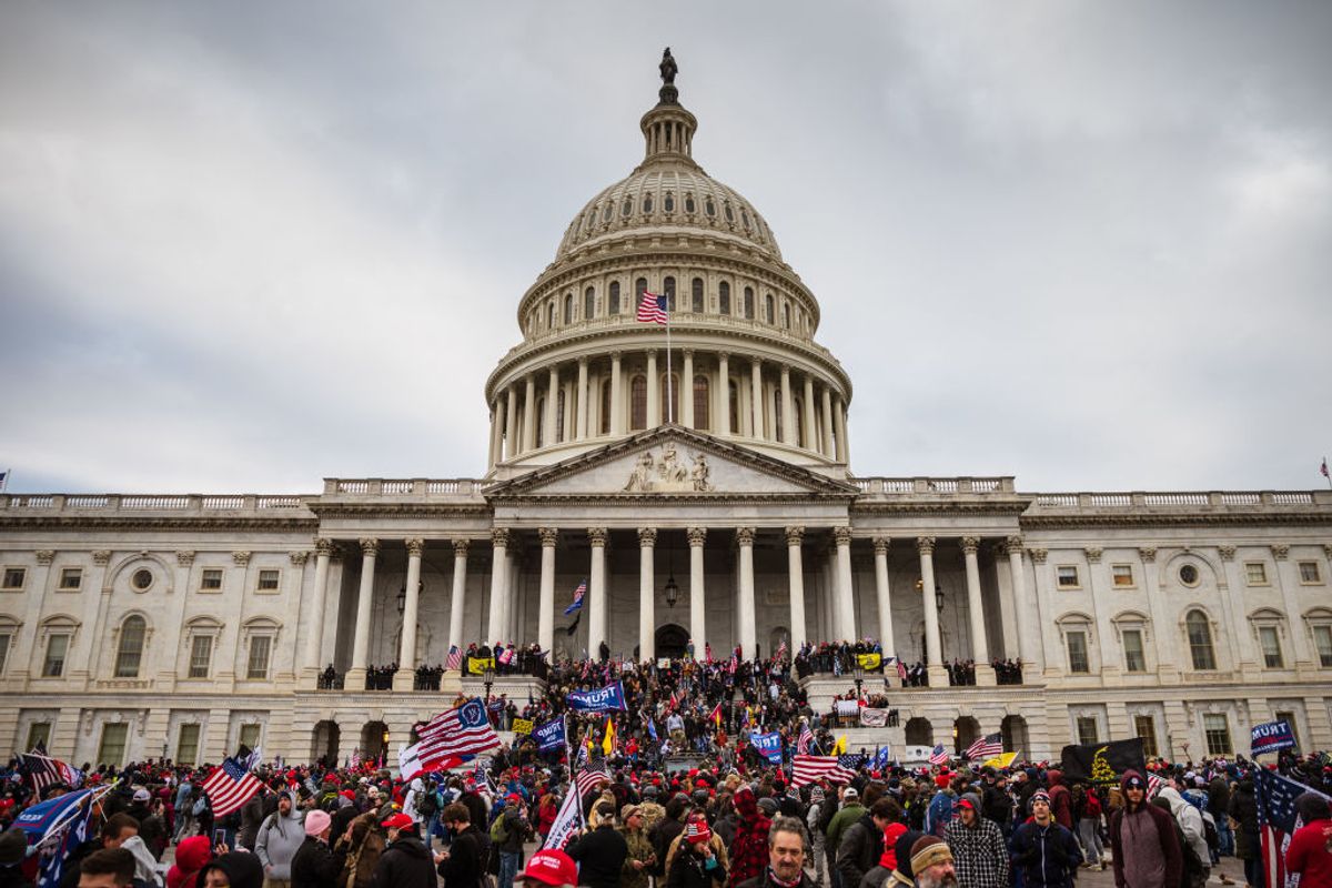 WASHINGTON, DC - JANUARY 06: A large group of pro-Trump protesters stand on the East steps of the Capitol Building after storming its grounds on January 6, 2021 in Washington, DC. A pro-Trump mob stormed the Capitol, breaking windows and clashing with police officers. Trump supporters gathered in the nation's capital today to protest the ratification of President-elect Joe Biden's Electoral College victory over President Trump in the 2020 election. (Photo by Jon Cherry/Getty Images) (Jon Cherry/Getty Images)