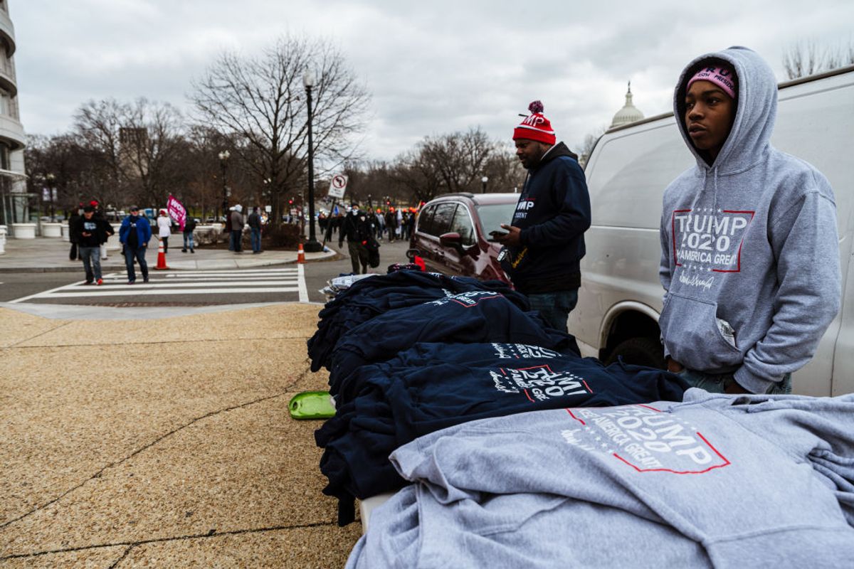 WASHINGTON, DC - JANUARY 06: Street vendors selling President Donald Trump memorabilia are seen on the sidewalk near the U.S. Capitol Building on January 6, 2021 in Washington, DC. A pro-Trump mob stormed the Capitol, breaking windows and clashing with police officers. Trump supporters gathered in the nation's capital today to protest the ratification of President-elect Joe Biden's Electoral College victory over President Trump in the 2020 election. (Photo by Jon Cherry/Getty Images) (John Cherry / Getty Images)
