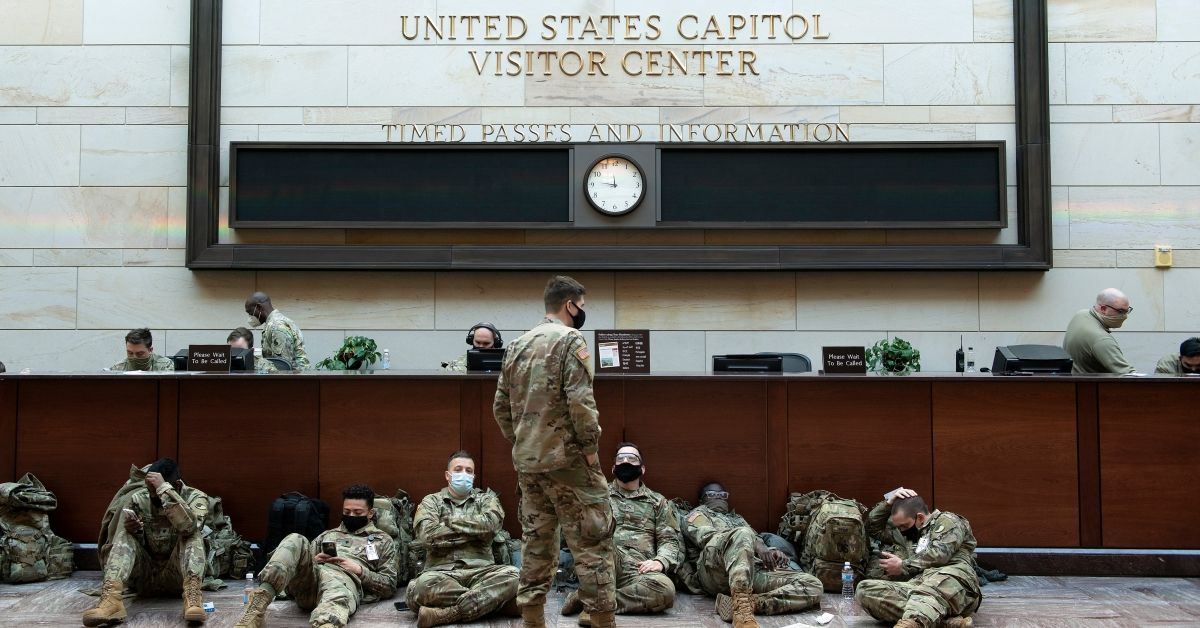 Members of the National Guard rest in the Capitol Visitors Center on Capitol Hill in Washington, DC, January 13, 2021, ahead of an expected House vote impeaching US President Donald Trump. - The Democrat-controlled US House of Representatives on Wednesday opened debate on a historic second impeachment of President Donald Trump over his supporters' attack of the Capitol that left five dead.Lawmakers in the lower chamber are expected to vote for impeachment around 3:00 pm (2000 GMT) -- marking the formal opening of proceedings against Trump. (Photo by Brendan Smialowski / AFP) (Photo by BRENDAN SMIALOWSKI/AFP via Getty Images) (BRENDAN SMIALOWSKI/AFP via Getty Images)