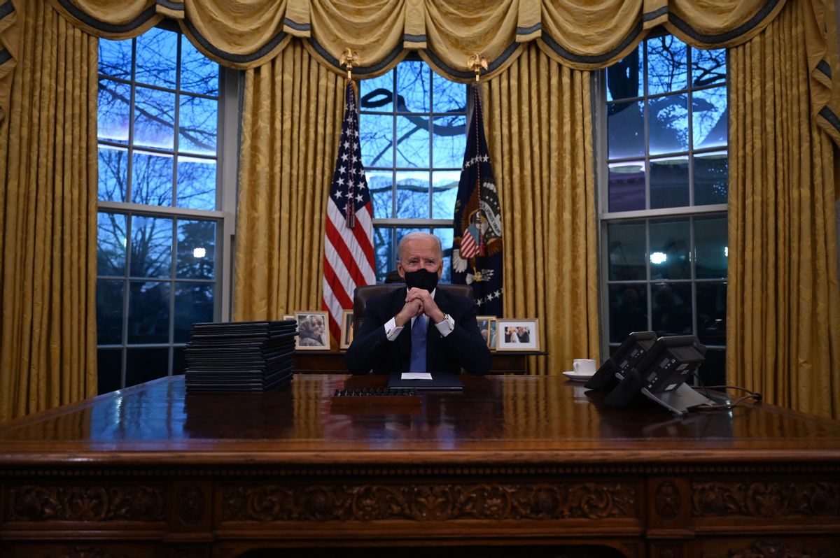 US President Joe Biden sits in the Oval Office at the White House in Washington, DC, after being sworn in at the US Capitol on January 20, 2021. - US President Joe Biden signed a raft of executive orders to launch his administration, including a decision to rejoin the Paris climate accord. The orders were aimed at reversing decisions by his predecessor, reversing the process of leaving the World Health Organization, ending the ban on entries from mostly Muslim-majority countries, bolstering environmental protections and strengthening the fight against Covid-19. (Photo by Jim WATSON / AFP) (Photo by JIM WATSON/AFP via Getty Images) (Jim Watson/AFP Via Getty Images)