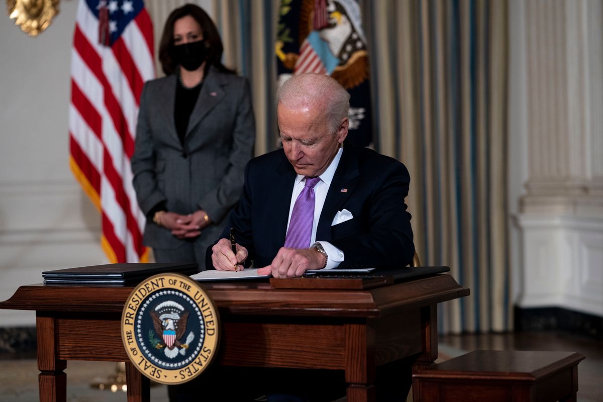 WASHINGTON, DC - JANUARY 26: (L-R) Vice President Kamala Harris looks on as U.S. President Joe Biden signs executives orders related to his racial equity agenda in the State Dining Room of the White House on January 26, 2021 in Washington, DC. President Biden signed executive actions Tuesday on housing and justice reforms, including a directive to the Department of Justice to end its use of private prisons. (Photo by Doug Mills-Pool/Getty Images) (Doug Mills-Pool/Getty Images)
