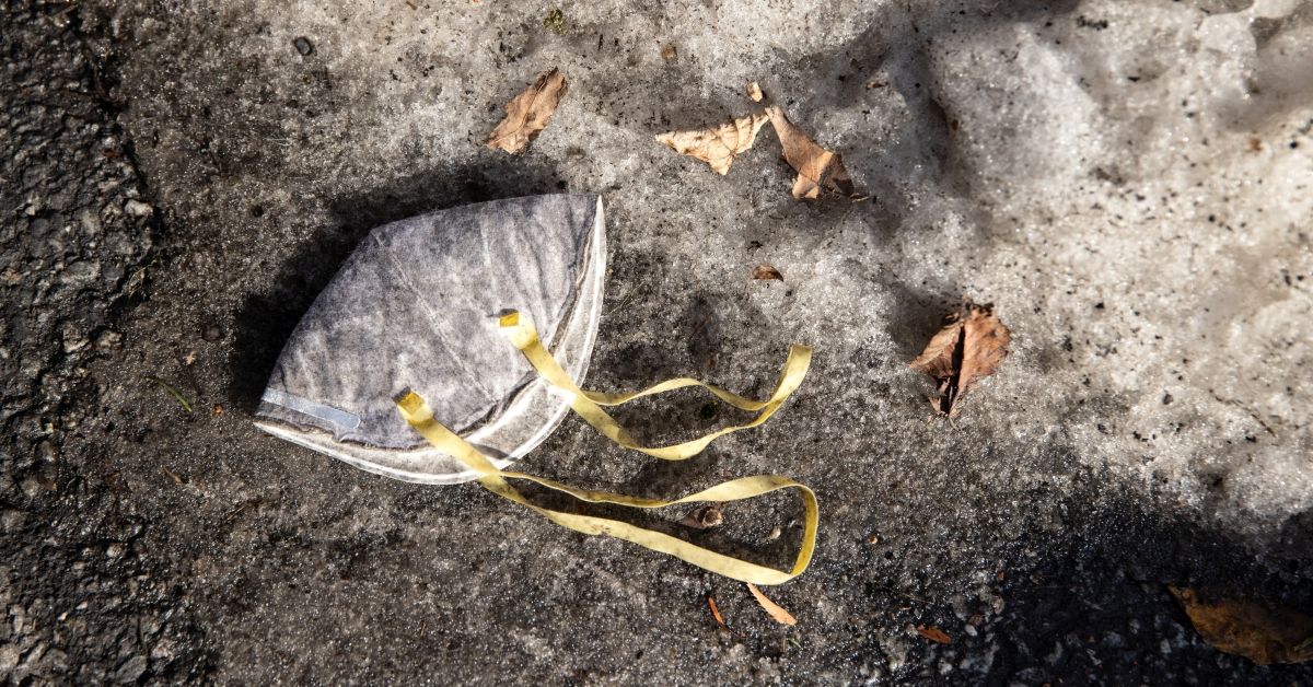 WHITE PLAINS, NEW YORK - DECEMBER 23: A mask lies in the snow outside an apartment building on December 23, 2020 in White Plains, New York. Contracted by local hospitals, Empress EMS sends paramedics for follow-up visits to patients, some still COVID-19 positive, after their discharge from hospital stays. The visits are designed to help keep patients with chronic conditions healthy and out of the hospital, where they could either contract or spread COVID-19. (Photo by John Moore/Getty Images) (John Moore/Getty Images)