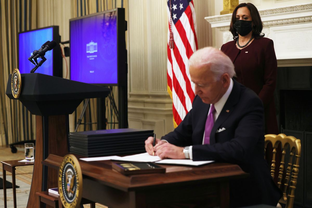 WASHINGTON, DC - JANUARY 21: U.S. President Joe Biden signs an executive order as Vice President Kamala Harris looks on during an event in the State Dining Room of the White House January 21, 2021 in Washington, DC. President Biden delivered remarks on his administration’s COVID-19 response, and signed executive orders and other presidential actions. (Photo by Alex Wong/Getty Images) (Alex Wong/Getty Images)