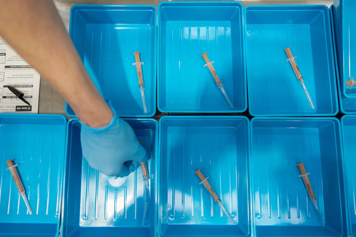 SUNDERLAND, ENGLAND - JANUARY 26: A member of the medical staff at the NHS Nightingale North East hospital lays out syringes of the AstraZeneca/Oxford University Covid-19 Vaccine on January 26, 2021 in Sunderland, England. The 460-bed hospital was created in the spring, as England's health system grappled with the first wave of covid-19 infections. It was placed on standby but never admitted patients. Based at the Washington International Advanced Manufacturing Park (IAMP) development the building was to be used as part of the region's advanced manufacturing sector until it was repurposed for use as a temporary hospital. (Photo by Ian Forsyth/Getty Images) (Ian Forsyth/Stringer)