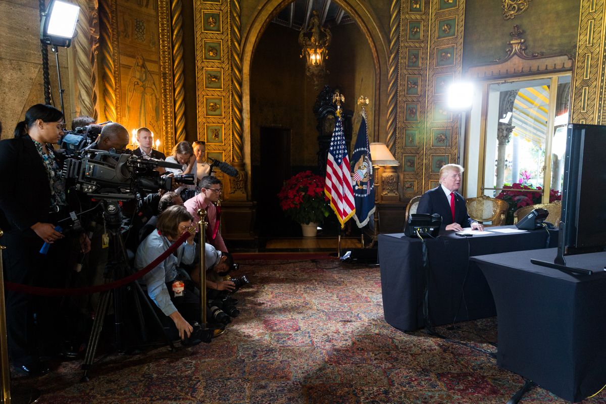 President Donald J. Trump talks with members of the military via video tele conference Sunday, December 24, 2017, from the library of Mar-a-Lago in West Palm Beach, Florida.   (Official White House Photo by Shealah Craighead) (The White House/Wikimedia Commons)