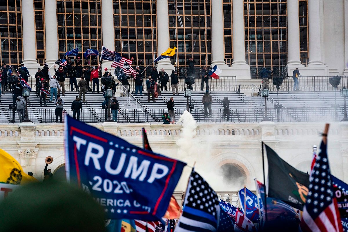 Supporters of US President Donald Trump clash with the US Capitol police during a riot at the US Capitol on January 6, 2021, in Washington, DC. - Donald Trump's supporters stormed a session of Congress held January 6 to certify Joe Biden's election win, triggering unprecedented chaos and violence at the heart of American democracy and accusations the president was attempting a coup. (Photo by ALEX EDELMAN / AFP) (Photo by ALEX EDELMAN/AFP via Getty Images) (ALEX EDELMAN/AFP via Getty Images)