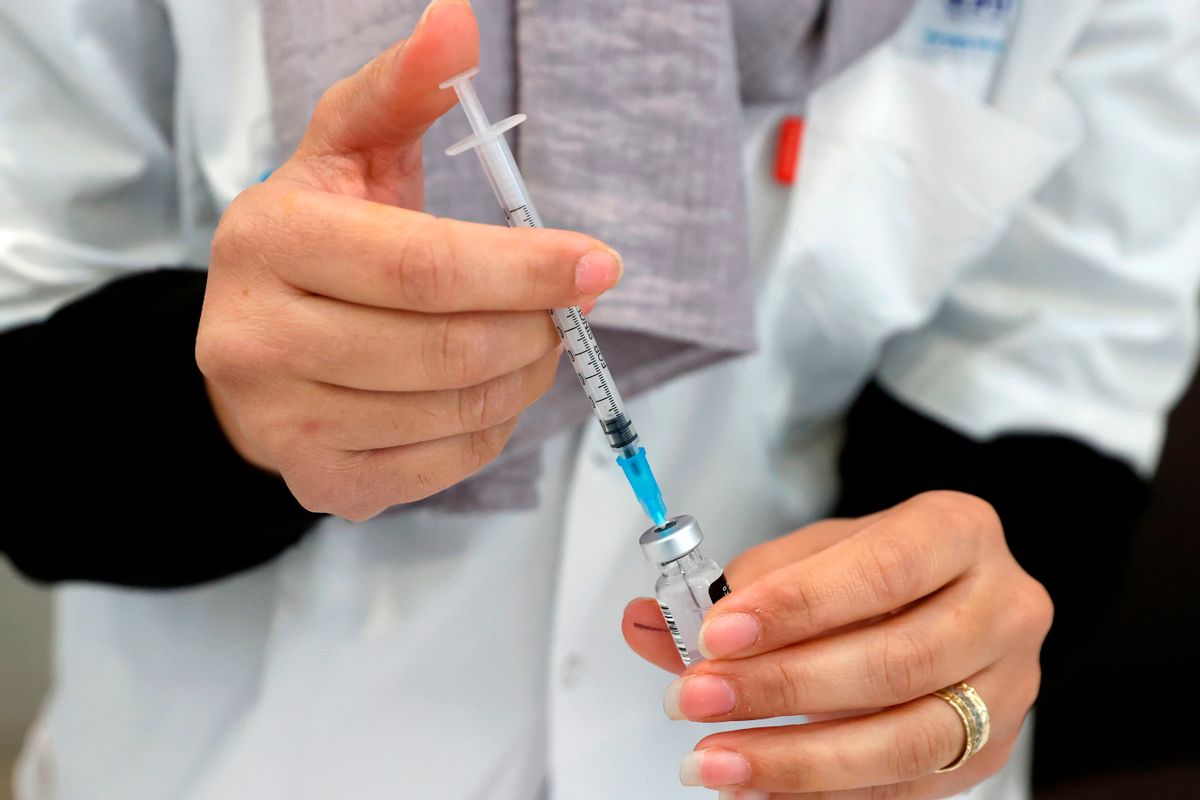 A healthcare worker prepares a dose of COVID-19 vaccine at Maccabi Health Services in the Israeli coastal city of Herzliya, north of Tel Aviv, on December 21, 2020. - Israel has ordered 14 million doses of the vaccine -- covering seven million people, as two doses are required per person for optimal protection -- from Pfizer as well as US biotech firm Moderna. (Photo by JACK GUEZ / AFP) (Photo by JACK GUEZ/AFP via Getty Images) (JACK GUEZ/AFP via Getty Images)
