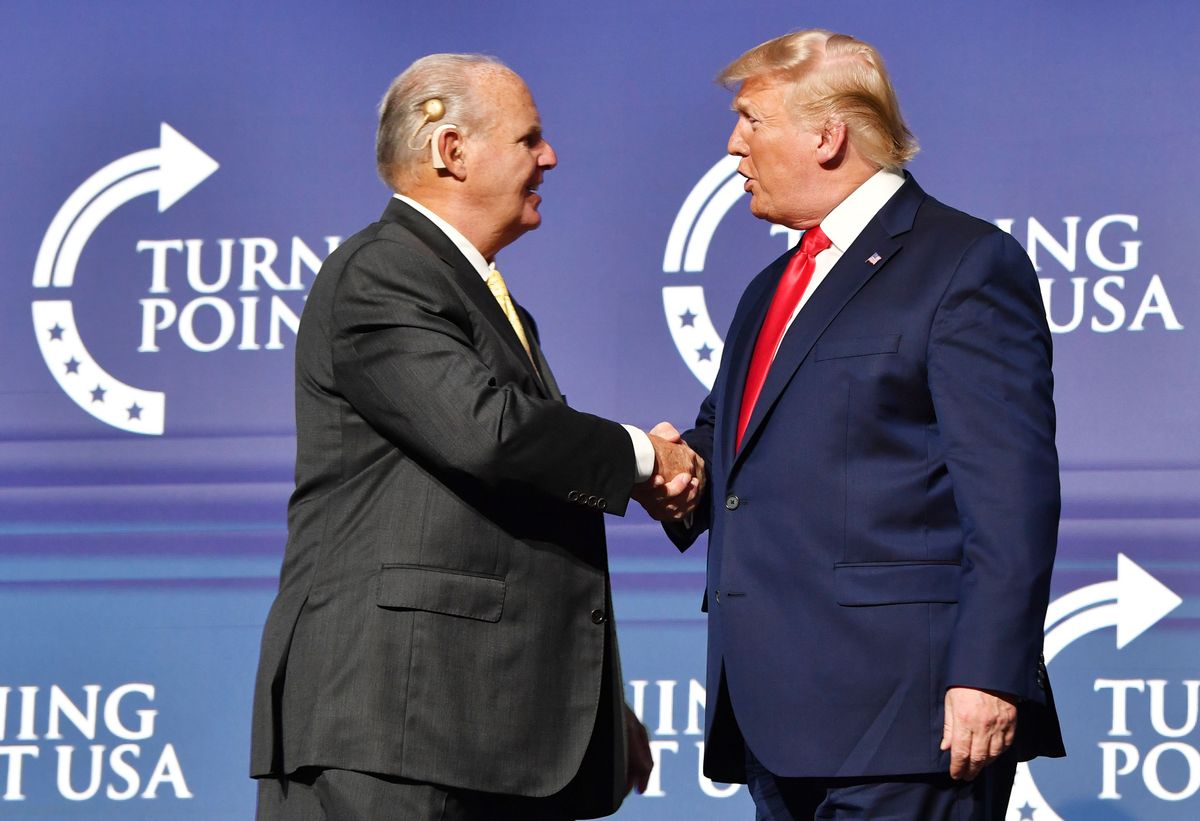 Rush Limbaugh shakes hands with US President Donald Trump during the Turning Point USA Student Action Summit at the Palm Beach County Convention Center in West Palm Beach, Florida on December 21, 2019. (Photo by Nicholas Kamm / AFP) (Photo by NICHOLAS KAMM/AFP via Getty Images) (NICHOLAS KAMM/AFP via Getty Images)