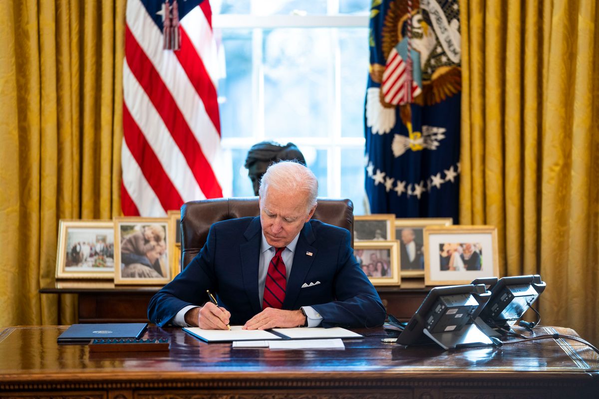 WASHINGTON, DC - JANUARY 28: U.S. President Joe Biden signs executive actions in the Oval Office of the White House on January 28, 2021 in Washington, DC. President Biden signed a series of executive actions Thursday afternoon aimed at expanding access to health care, including re-opening enrollment for health care offered through the federal marketplace created under the Affordable Care Act. (Photo by Doug Mills-Pool/Getty Images) (Pool / Getty Images)