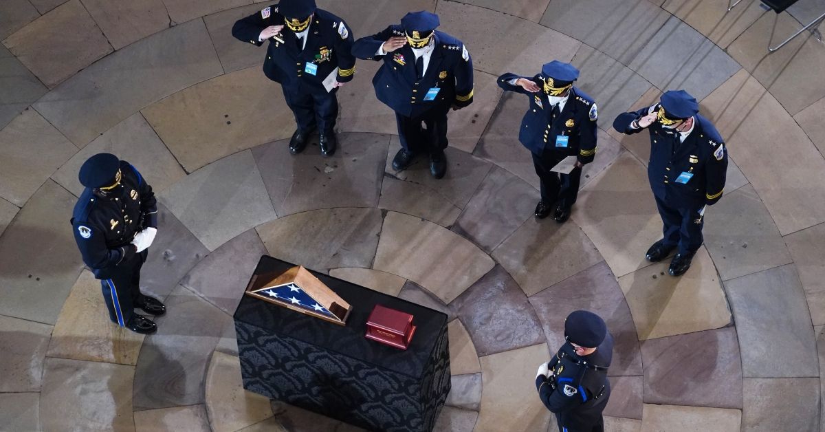 Mourners pay their respects during a ceremony for US Capitol Police officer Brian Sicknick as he lays in honor in the Rotunda of the US Capitol building on February 3, 2021, in Washington, DC. - The US Capitol police officer who died after being injured in the January 6 attack by pro-Trump rioters will lie in honor at the building's Rotunda, lawmakers said Friday, a mark of respect rarely bestowed. Brian Sicknick was reportedly struck in the head with a fire extinguisher while struggling with the rioters who swarmed through the halls of Congress (Photo by Kevin Dietsch / POOL / AFP) (Photo by KEVIN DIETSCH/POOL/AFP via Getty Images) (KEVIN DIETSCH/POOL/AFP via Getty Images)