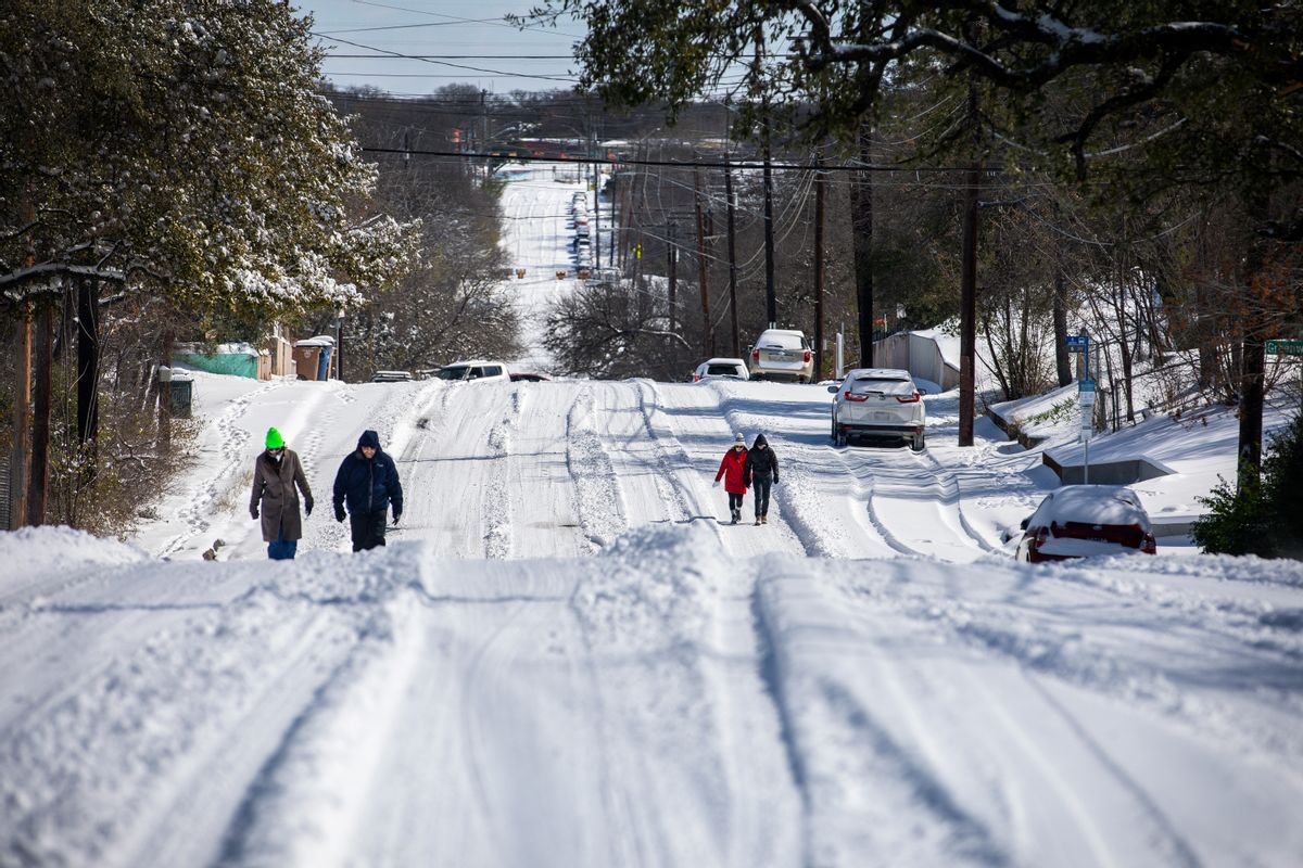 AUSTIN, TX - FEBRUARY 15: Pedestrians walk on an icy road on February 15, 2021 in East Austin, Texas. Winter storm Uri has brought historic cold weather to Texas, causing traffic delays and power outages, and storms have swept across 26 states with a mix of freezing temperatures and precipitation. (Photo by Montinique Monroe/Getty Images) (Montinique Monroe/Getty Images)
