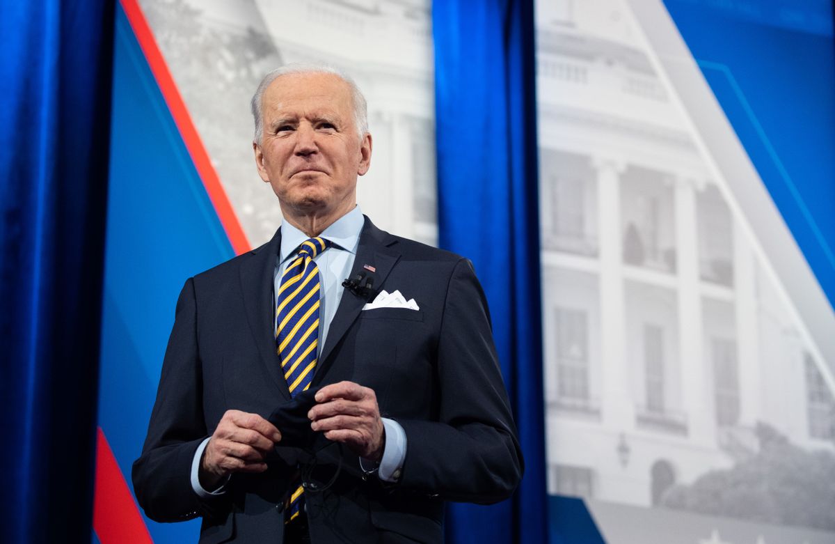 US President Joe Biden holds a face mask as he participates in a CNN town hall at the Pabst Theater in Milwaukee, Wisconsin, February 16, 2021. (Photo by SAUL LOEB / AFP) (Photo by SAUL LOEB/AFP via Getty Images) (SAUL LOEB/AFP via Getty Images)