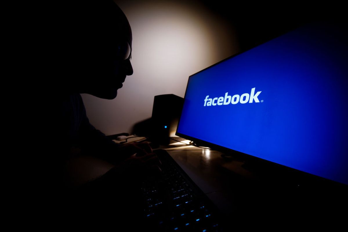 A man looks at a computer screen with a Facebook logo in Warsaw, Poland on February 21, 2021. Paid-for messages from some 11 groups aiemd at raising awareness of vaccines against COVID-19 were accidentally flagged as political messages a POLITICO investigation from last September revealed. (Photo illustration by Jaap Arriens/NurPhoto via Getty Images) (Getty Images, stock)