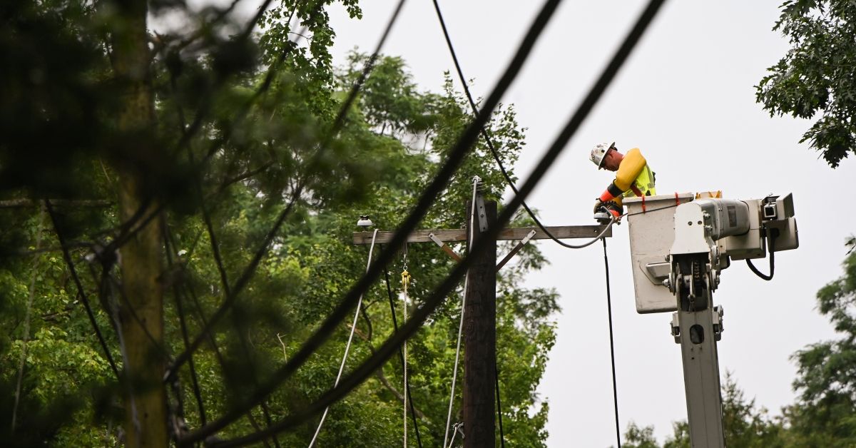 Fort Salonga, N.Y.: worker in a bucket truck addresses downed power lines along Bread and Cheese Hollow Road in Fort Salonga, New York after a tree knocked them out following tropical storm Isaias on Aug. 6, 2020. (Photo by Steve Pfost/Newsday via Getty Images) (Steve Pfost/Newsday via Getty Images)