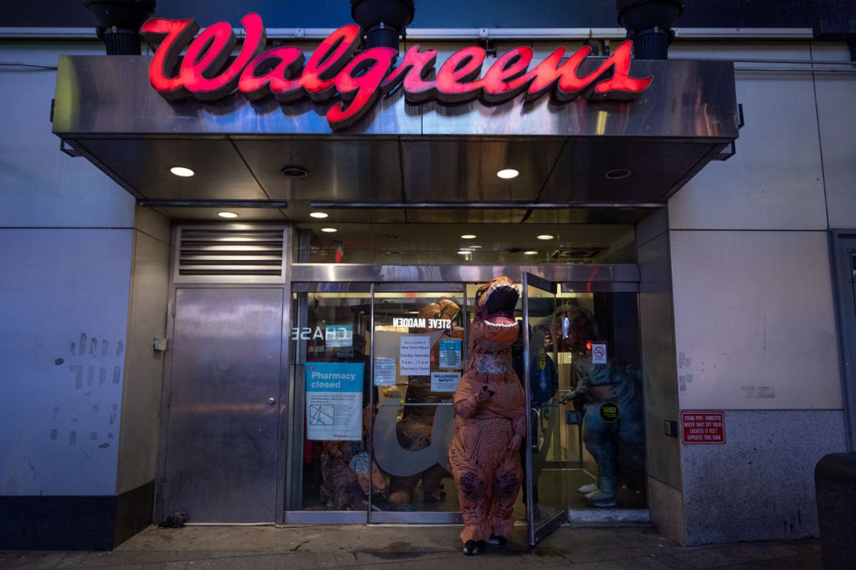 NEW YORK, NEW YORK - OCTOBER 31: A person wearing a dinosaur costume walks out of a Walgreens in Times Square on October 31, 2020 in New York City. Many Halloween events have been canceled or adjusted with additional safety measures due to the ongoing coronavirus (COVID-19) pandemic. (Photo by Alexi Rosenfeld/Getty Images) (Alexi Rosenfeld/Getty Images)