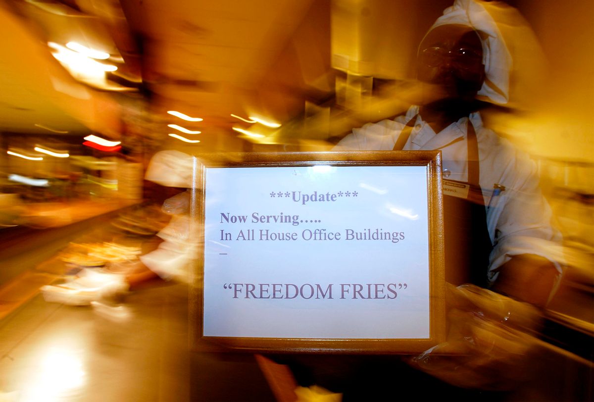 A US Capitol food service worker holds up a sign 13 March, 2003 renaming French fries to "Feedom Fries" on Capitol Hill, in Washington, DC. All of the House Office Building are serving the fries. Republican lawmakers expressed their displeasure with France's stance on Iraq by removing the name "French" fries from a House of Representatives cafeteria, and replacing the item with "freedom fries."   AFP PHOTO Stephen JAFFE (Photo by STEPHEN JAFFE / AFP) (Photo by STEPHEN JAFFE/AFP via Getty Images) (STEPHEN JAFFE/AFP via Getty Images)