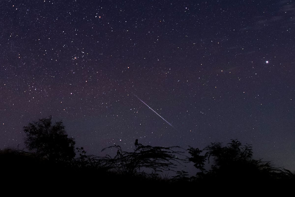 TOPSHOT - This photo taken late December 14, 2018 with a long time exposure shows a meteor streaking through the night sky over Myanmar during the Geminid meteor shower seen from Wundwin township near Mandalay city. (Photo by Ye Aung THU / AFP)        (Photo credit should read YE AUNG THU/AFP via Getty Images) (Ye Aung Thu/Contributor)