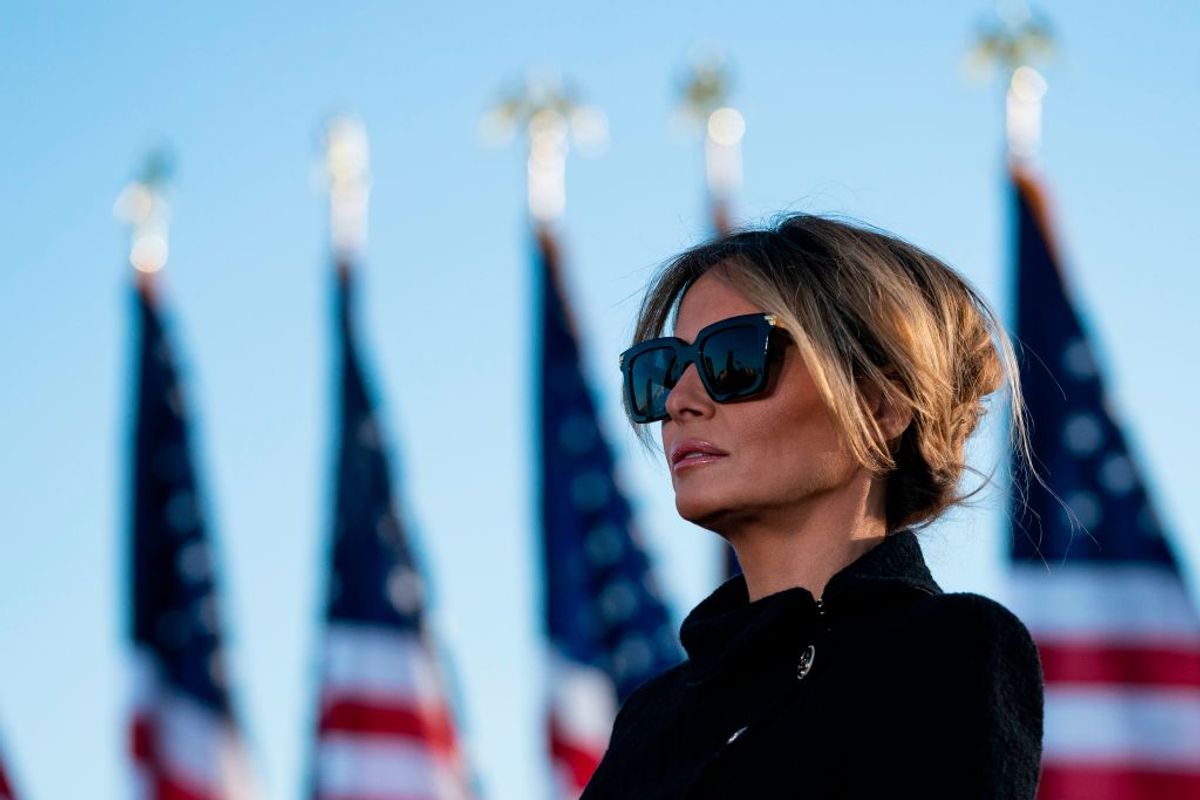 Outgoing First Lady Melania Trump listens as her husband Outgoing US President Donald Trump addresses guests at Joint Base Andrews in Maryland on January 20, 2021. - President Trump and the First Lady travel to their Mar-a-Lago golf club residence in Palm Beach, Florida, and will not attend the inauguration for President-elect Joe Biden. (Photo by ALEX EDELMAN / AFP) (Photo by ALEX EDELMAN/AFP via Getty Images) (ALEX EDELMAN/AFP via Getty Images)